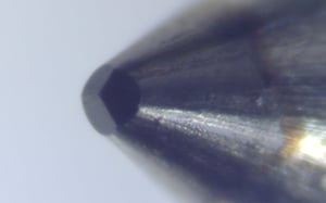 Close-up of a Berkovich indenter tip for hardness testing.