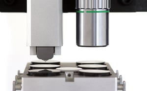 Side view of FT-I04 Femto-Indenter highlighting the tip and sample stage for nanoscale testing.