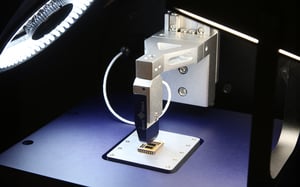 Close-up of FT-MTA03's microforce sensing probe performing a measurement on a sample.